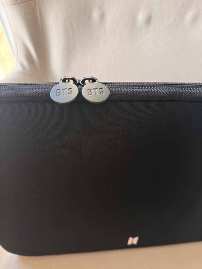 BTS Laptop Sleeve Pouch Bag (Category: Laptop Bags & Sleeves) located in Quezon City. Submitted by stylesaverph (Listing ID 1450566627, Image 3). Description: - Black laptop sleeve with iconic BTS logo - Secure zipper closure with custom BTS zipper pulls - Padded interior for optimal laptop protection - inner lining is color purple - Designed to fit most standard laptop sizes - Essential accessory for any ARMY on the move.