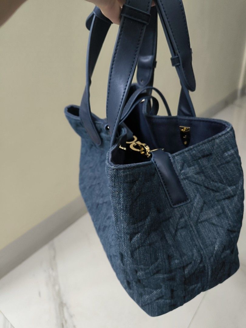 Christian Dior Denim Trotter Bag (Category: Luxury Bags & Wallets) located in Lipa City. Submitted by rlr27 (Listing ID 1450704861, Image 3). Description: - Blue denim with quilted pattern - Gold 'CD' charm detail - Genuine leather handles and trim - Interior satin lining - Ideal for everyday use - Classic, timeless design.