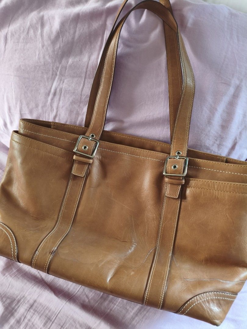 Coach vintage brown leather shoulder bag (Category: Shoulder Bags) located in Pasig City. Submitted by elabart (Listing ID 1450581976, Image 2). Description: - 2000s coach leather bag - dimensions: 46x26 cm - has lots of pocket and space. can fit a laptop. - issue: with light water stain (pls see photos) - i bought this from another seller with the stain already there. I haven't clean it yet since i got it. - aside from the water stain, the bag i