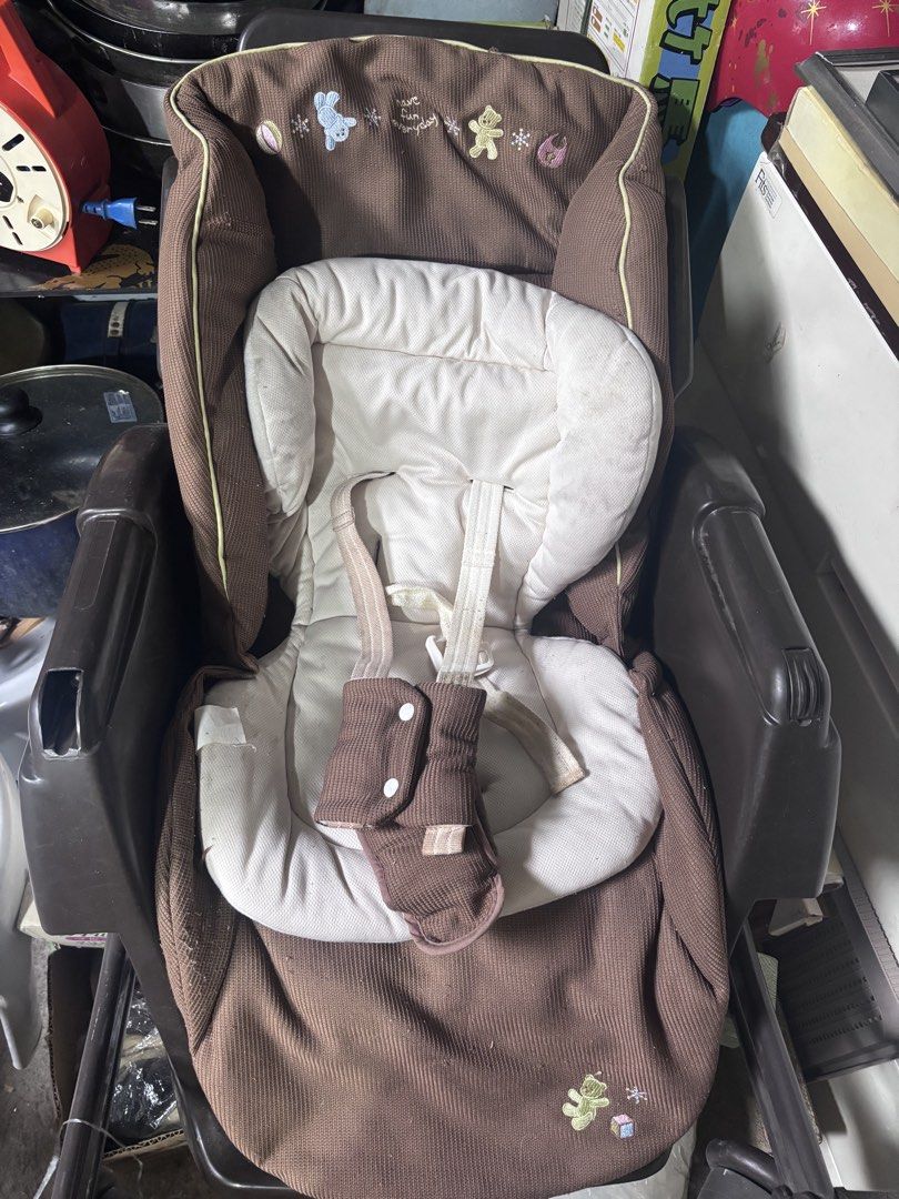 Combi Baby Stroller (Category: Strollers) located in Quezon City. Submitted by m2yjapansurplus_quezoncity (Listing ID 1450710804, Image 2). Description: - baby bed bouncher nalang nawawala ang Table ha Brown baby stroller with a comfortable cream-colored padded seat. - Features a secure 5-point harness for your baby's safety. - Unique corduroy textured fabric. - Shows minor signs of wear on the padding and harness straps, but fully functional. - 