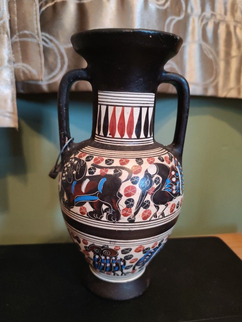 Decorative Amphora Vase with Ancient Greek Style Art (Category: Vases & Decorative Bowls) located in Kuala Lumpur. Submitted by gentlepenguin.6b8aad (Listing ID 1450663778, Image 2). Description: - Decorative amphora vase - Ancient Greek-inspired artwork - Features mythological creatures and geometric patterns - Colors: Black, red, and blue - Two handles and a flared rim - Ideal for display or unique home decor.