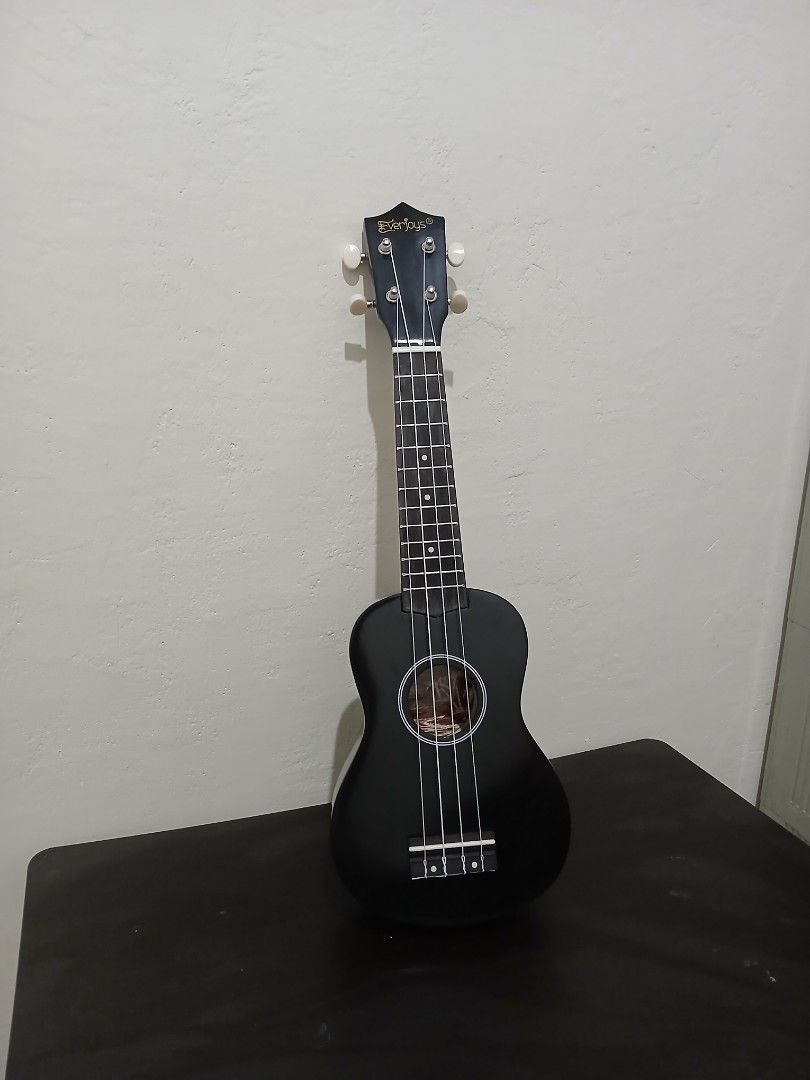 EVERJOYS 21" Black Ukelele (Category: Musical Instruments) located in Umingan. Submitted by eirevelle_thrifts (Listing ID 1450666888, Image 1). Description: Condition: Fully functional and plays well. There is a white discoloration on the wood around the bridge (where the strings are attached). I'm not sure what caused it, and it doesn't come off when wiped. It appears to be a cosmetic issue only and does not affect the sound or playability. Incl