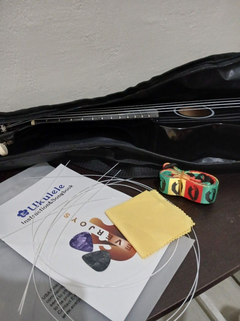 EVERJOYS 21" Black Ukelele (Category: Musical Instruments) located in Umingan. Submitted by eirevelle_thrifts (Listing ID 1450666888, Image 2). Description: Condition: Fully functional and plays well. There is a white discoloration on the wood around the bridge (where the strings are attached). I'm not sure what caused it, and it doesn't come off when wiped. It appears to be a cosmetic issue only and does not affect the sound or playability. Incl