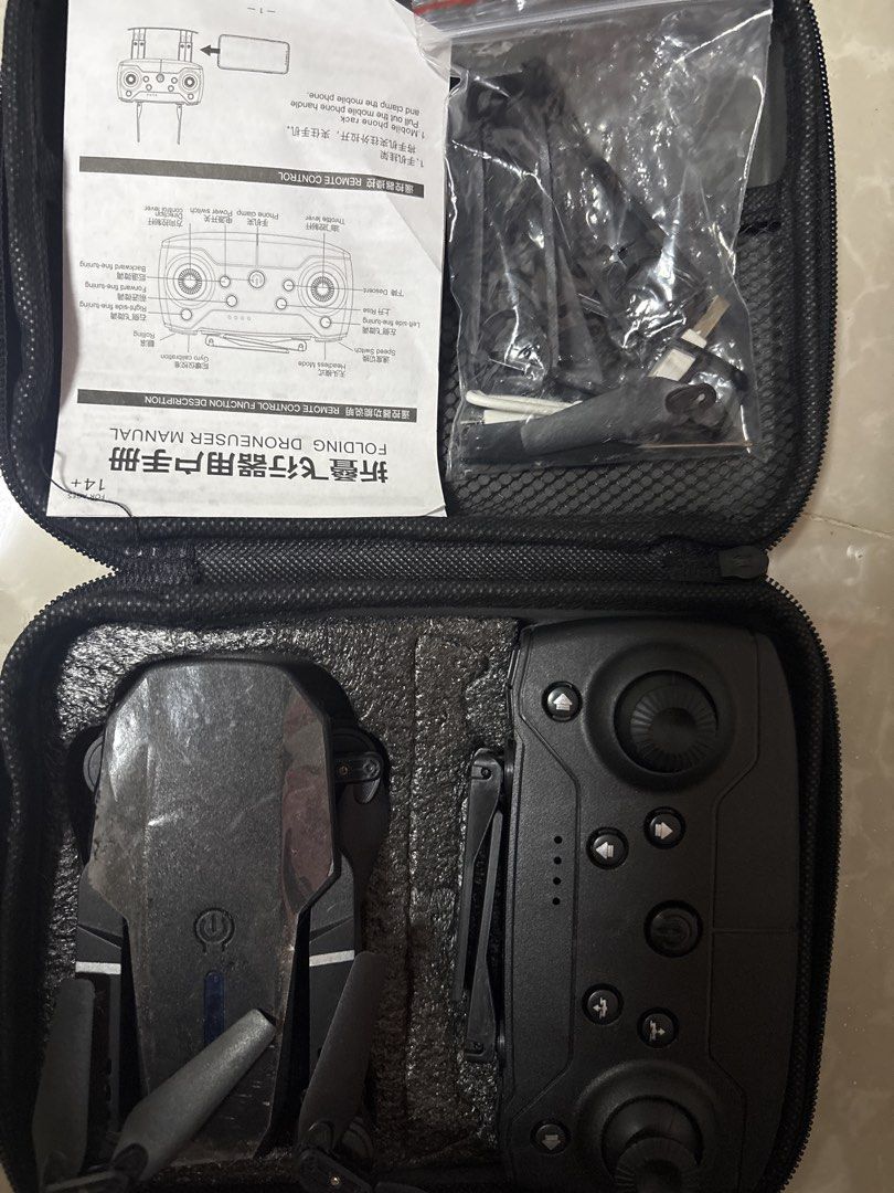 Folding Drone with Remote Controller and Case (Category: Drones) located in Quezon City. Submitted by lottiebunny (Listing ID 1450665043, Image 1). Description: - Black folding drone - Includes remote controller and charging cables - Comes in a protective case for easy carrying - Ideal for beginners - User manual included.