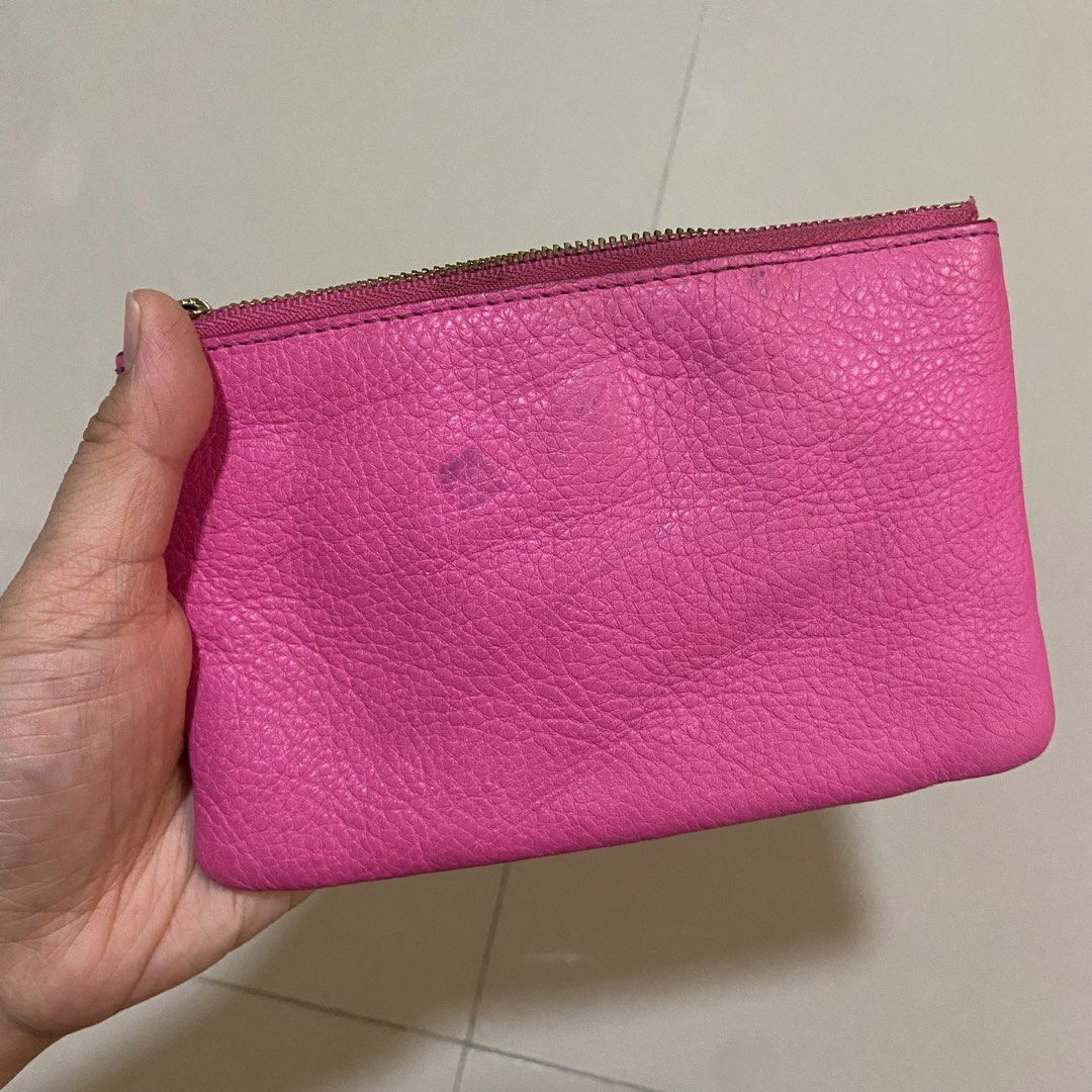 Kate Spade Pink Leather Wristlet Pouch (Category: Purses & Pouches) located in Cavite. Submitted by klosettekleanup (Listing ID 1450706527, Image 3). Description: - Genuine pink pebbled leather Kate Spade wristlet - Iconic silver spade logo on the front - Stylish black and white striped interior lining - Secure zipper closure with a convenient wrist strap - Small stain on the back, clearly shown in photos - Ideal size for carrying your daily esse