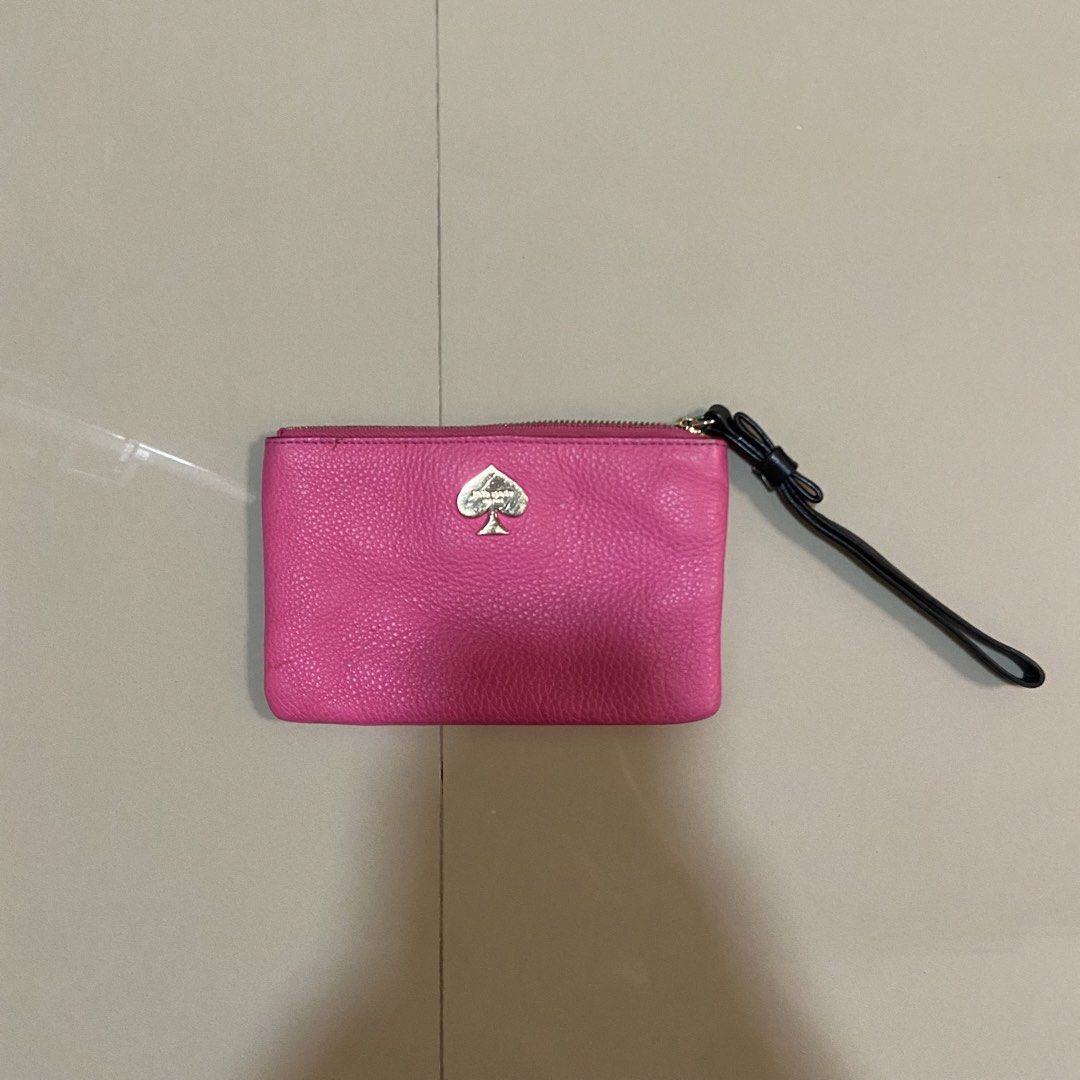 Kate Spade Pink Leather Wristlet Pouch (Category: Purses & Pouches) located in Cavite. Submitted by klosettekleanup (Listing ID 1450706527, Image 1). Description: - Genuine pink pebbled leather Kate Spade wristlet - Iconic silver spade logo on the front - Stylish black and white striped interior lining - Secure zipper closure with a convenient wrist strap - Small stain on the back, clearly shown in photos - Ideal size for carrying your daily esse