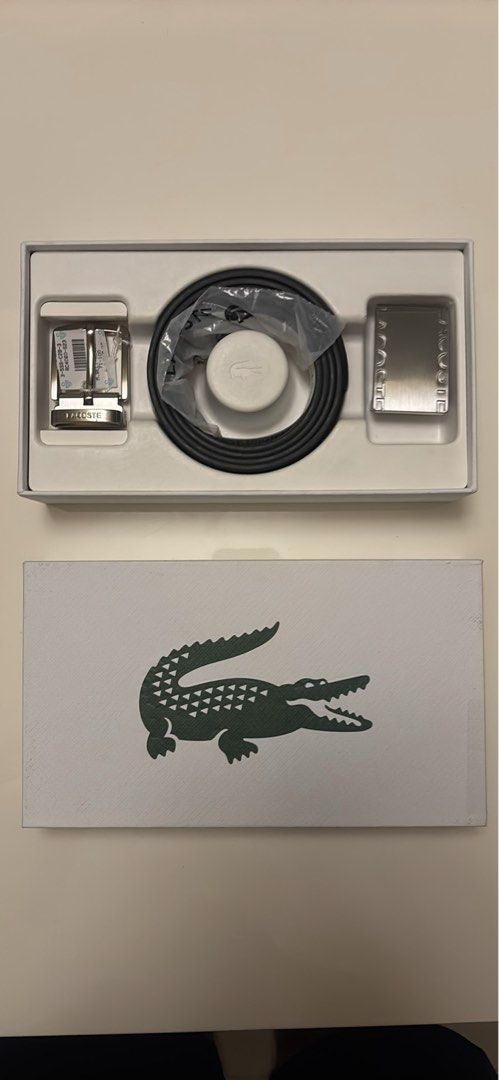 Lacoste Belt Set with Interchangeable Buckles (Category: Belts) located in Makati City. Submitted by ed_______ (Listing ID 1450685208, Image 1). Description: - Authentic Lacoste belt set - Includes black belt strap - Comes with two silver buckles: - One buckle with engraved Lacoste logo - One buckle with Lacoste name on the sides - All items in original Lacoste box - Makes a great gift idea.