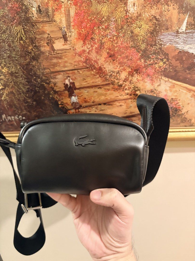 Lacoste Black Leather Crossbody Bag (Category: Cross-body Bags) located in Makati City. Submitted by goodbuyitems (Listing ID 1450654514, Image 1). Description: condition 9/10 decluttering. no issue. seldom used mini size. dimension 10 x 10 x 10 millimetres Black leather crossbody bag from Lacoste. Small and compact, great for essentials. Zipper closure. Adjustable strap. The logo is embossed on the front. Interior tag shows brand details..