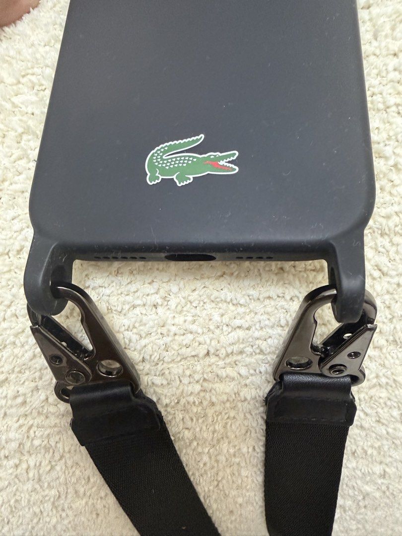 Lacoste iPhone 14/15 Plus case (Category: Cases & Sleeves) located in Pasig City. Submitted by jenrosesteller (Listing ID 1450725789, Image 3). Description: Used only once during HK Disneyland Trip 💚 Can pass as New. Very convenient for travelling with Kids and for taking photos or even on daily use..