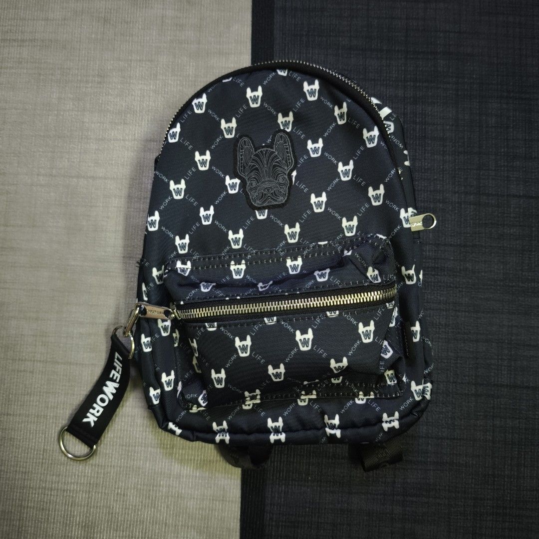 LIFEWORK Monogram Mini Backpack (Category: Backpacks) located in Cheras. Submitted by hypestandard (Listing ID 1450717394, Image 1). Description: - LIFEWORK Monogram Mini Backpack - Black Colour - Measurements 20cm (w) x 27cm (h) x 7.5cm (d) - Front patch of a French bulldog face - Main zip compartment - Smaller front zip pocket - Adjustable straps - Comes with 'LIFEWORK' tag - Ideal for everyday use or travel.