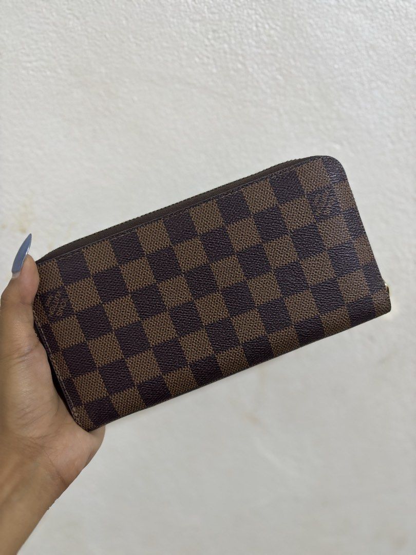 Louis Vuitton Damier Ebene Zippy Wallet (Category: Luxury Bags & Wallets) located in Cagayan de Oro. Submitted by aezamirae (Listing ID 1450655119, Image 1). Description: - Louis Vuitton wallet - Classic Damier Ebene canvas - Secure zip-around closure - Ample card slots and compartments for organization - Elegant gold-tone hardware - Perfect for keeping your essentials tidy.