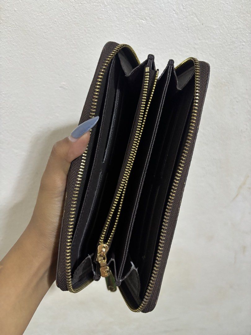 Louis Vuitton Damier Ebene Zippy Wallet (Category: Luxury Bags & Wallets) located in Cagayan de Oro. Submitted by aezamirae (Listing ID 1450655119, Image 2). Description: - Louis Vuitton wallet - Classic Damier Ebene canvas - Secure zip-around closure - Ample card slots and compartments for organization - Elegant gold-tone hardware - Perfect for keeping your essentials tidy.