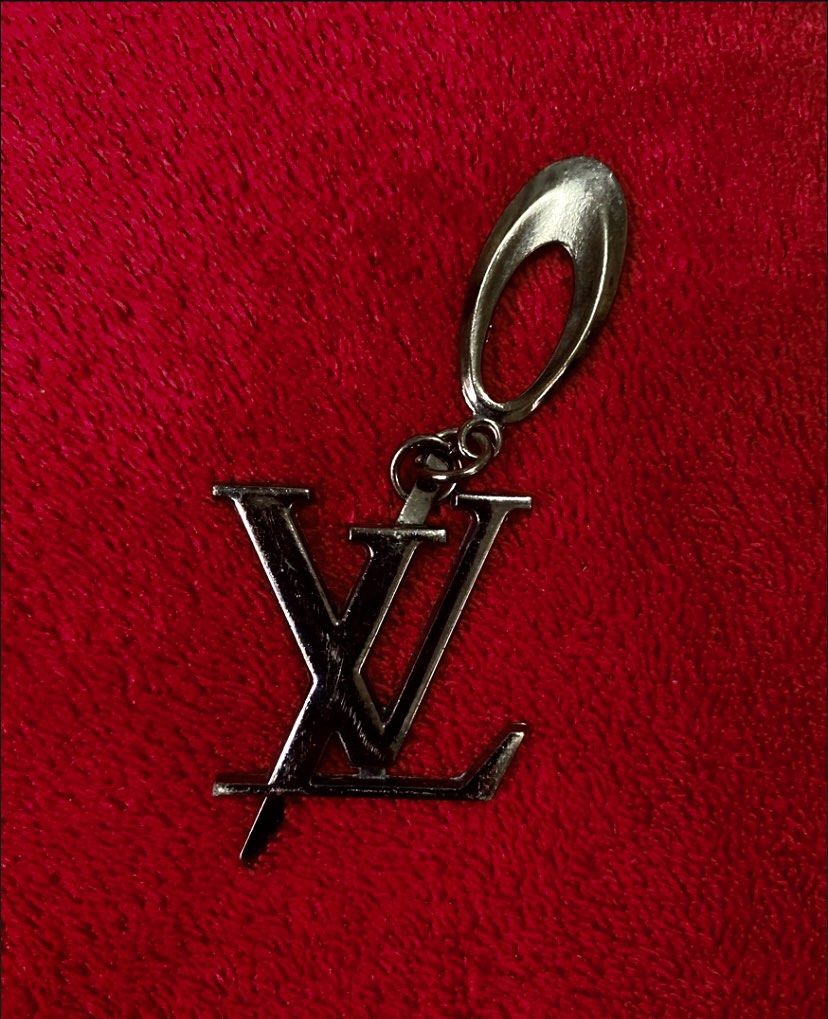 Louis Vuitton LV Logo Brooch Keychain Key Chain (Category: Luxury Accessories) located in Quezon City. Submitted by madame_royale (Listing ID 1450714839, Image 1). Description: WYSIWYG> What you see is what you get. - Features the iconic LV logo - Chrome Silver finish - Key attachment - Stylish accessory for keys or bags - Authentic Louis Vuitton charm - Features iconic LV monogram - Dark metallic finish - Versatile: attach to bags, keychains, or