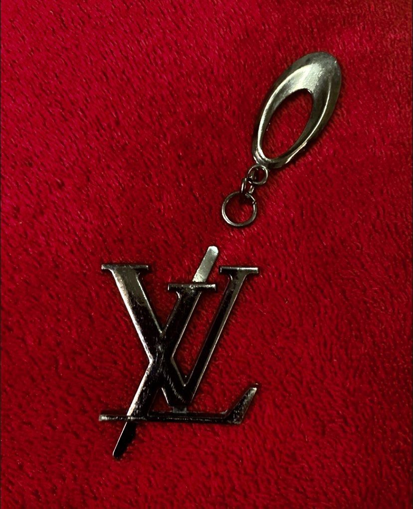 Louis Vuitton LV Logo Brooch Keychain Key Chain (Category: Luxury Accessories) located in Quezon City. Submitted by madame_royale (Listing ID 1450714839, Image 2). Description: WYSIWYG> What you see is what you get. - Features the iconic LV logo - Chrome Silver finish - Key attachment - Stylish accessory for keys or bags - Authentic Louis Vuitton charm - Features iconic LV monogram - Dark metallic finish - Versatile: attach to bags, keychains, or