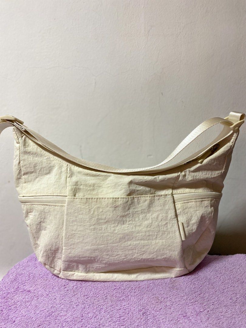 Lululemon Cream Nylon Shoulder Bag (Category: Shoulder Bags) located in Cabuyao City. Submitted by copitos (Listing ID 1450701003, Image 1). Description: - Cream colored Lululemon shoulder bag - Durable nylon material - Multiple zippered pockets on the front - Main compartment with zipper closure - Interior features a zippered pocket and mesh pockets - Adjustable strap for comfortable wear - Ideal for everyday use.