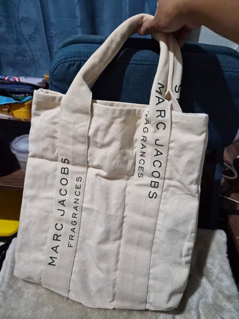Marc Jacobs Fragrances Canvas Tote Bag (Category: Luxury Bags & Wallets) located in Mandaue City. Submitted by chuchi152615 (Listing ID 1450537631, Image 3). Description: - Authentic Marc Jacobs canvas tote bag - Color: Beige - 'Marc Jacobs Fragrances' print on both sides - Sturdy canvas material with comfortable handles - Perfect for everyday use or as a stylish shopping bag - Classic and simple design.