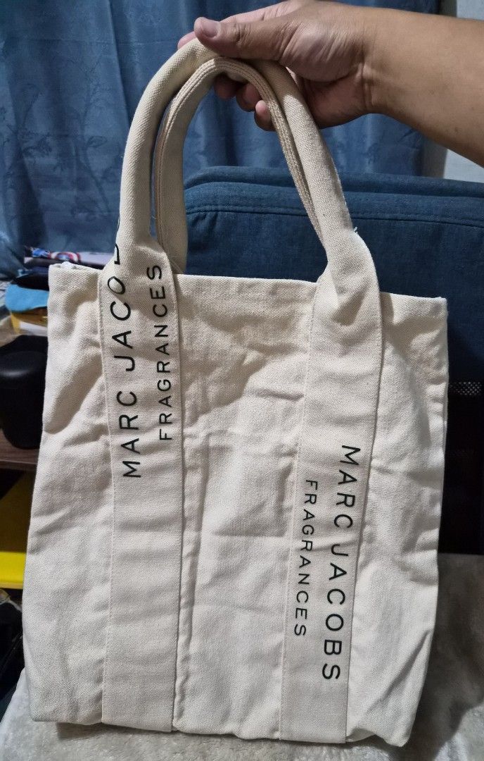 Marc Jacobs Fragrances Canvas Tote Bag (Category: Luxury Bags & Wallets) located in Mandaue City. Submitted by chuchi152615 (Listing ID 1450537631, Image 1). Description: - Authentic Marc Jacobs canvas tote bag - Color: Beige - 'Marc Jacobs Fragrances' print on both sides - Sturdy canvas material with comfortable handles - Perfect for everyday use or as a stylish shopping bag - Classic and simple design.