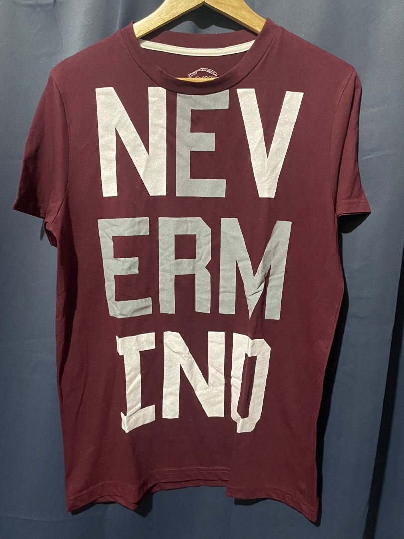 Maroon statement T-shirt with 'NEVERMIND' graphic print (Category: Tshirts & Polo Shirts ) located in Caloocan City. Submitted by jetcon (Listing ID 1450561567, Image 1). Description: - Stylish maroon t-shirt - Features a large 'NEVERMIND' graphic print in light grey - Short-sleeved, crew neck design - Comfortable and ideal for casual everyday wear - W: 20“ L: 27“ Gcash payment 1st + SF SF rates: 65 for NCR 85 for Luzon 100 for VisMin Ship via J&