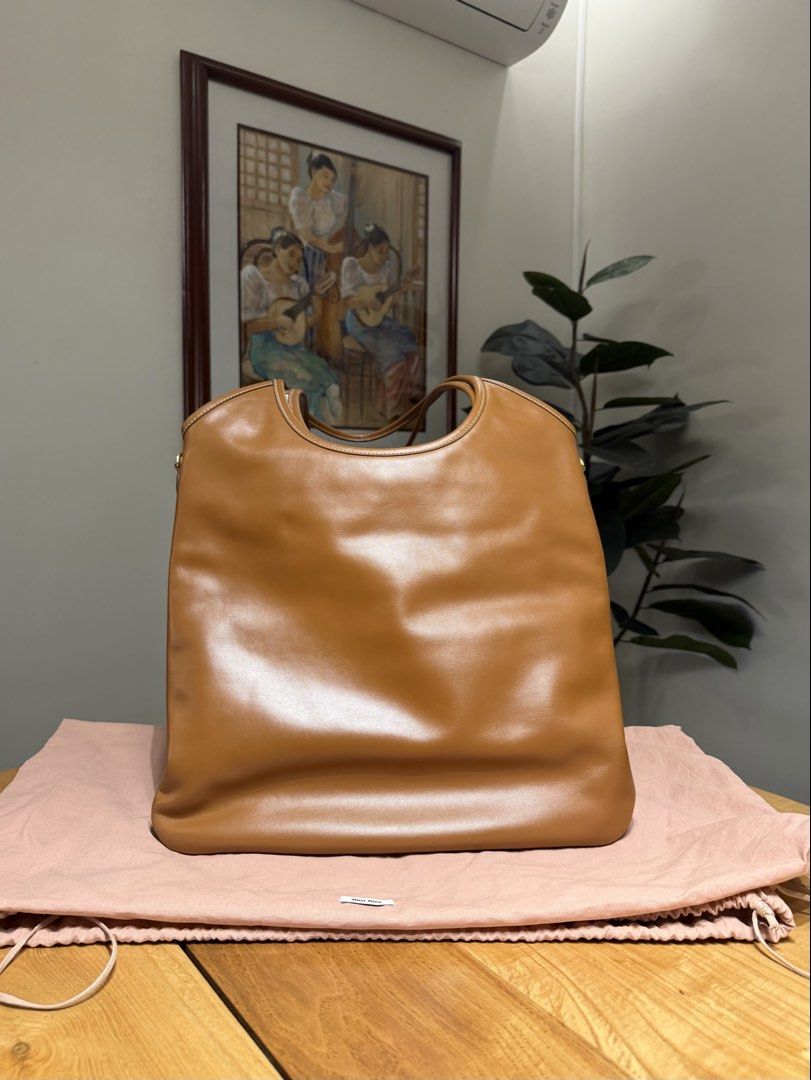 Miu Miu Leather Tote Bag (Category: Luxury Bags & Wallets) located in Paranaque City. Submitted by megsluxefinds (Listing ID 1450532521, Image 2). Description: Authentic Miu Miu Ivy Leather Tote Bag – Brown 🤎 Rank: Rank SA (used 2-3x only) Price: ₱90,000 Inclusions: Dust bag, cards, paper bag and receipt IG: @megsluxefinds.