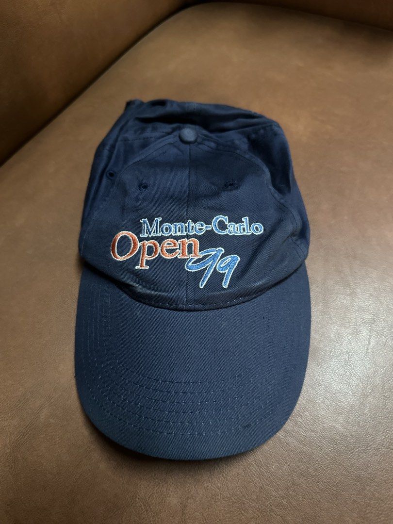 Monte-Carlo Open '99 Navy Blue Baseball Cap (Category: Caps & Hats) located in Manila. Submitted by clamchowder19 (Listing ID 1450583584, Image 1). Description: - Vintage navy blue baseball cap - Commemorates the Monte-Carlo Open 1999 - Features embroidered text and logo - Adjustable strap for a comfortable fit - Ideal for collectors and tennis enthusiasts.