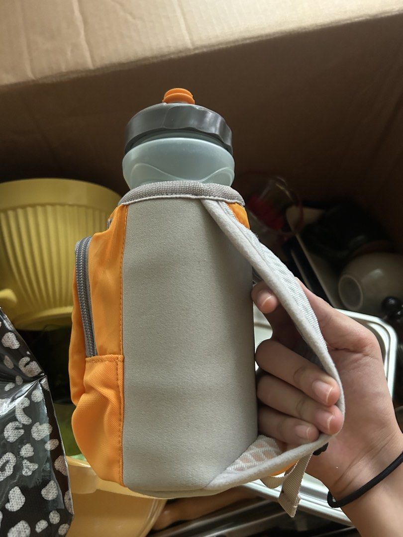Nathan Orange Water Bottle Holder with Pouch (Category: Water Bottles & Tumblers) located in Manila. Submitted by keyscaninet (Listing ID 1450605856, Image 2). Description: - Nathan brand water bottle holder - Bright orange color with grey pouch - Mini backpack design with straps for easy carrying - Zippered pocket on the pouch for essentials - Ideal for running, hiking, and outdoor activities - Keeps your water bottle secure and your belongings 