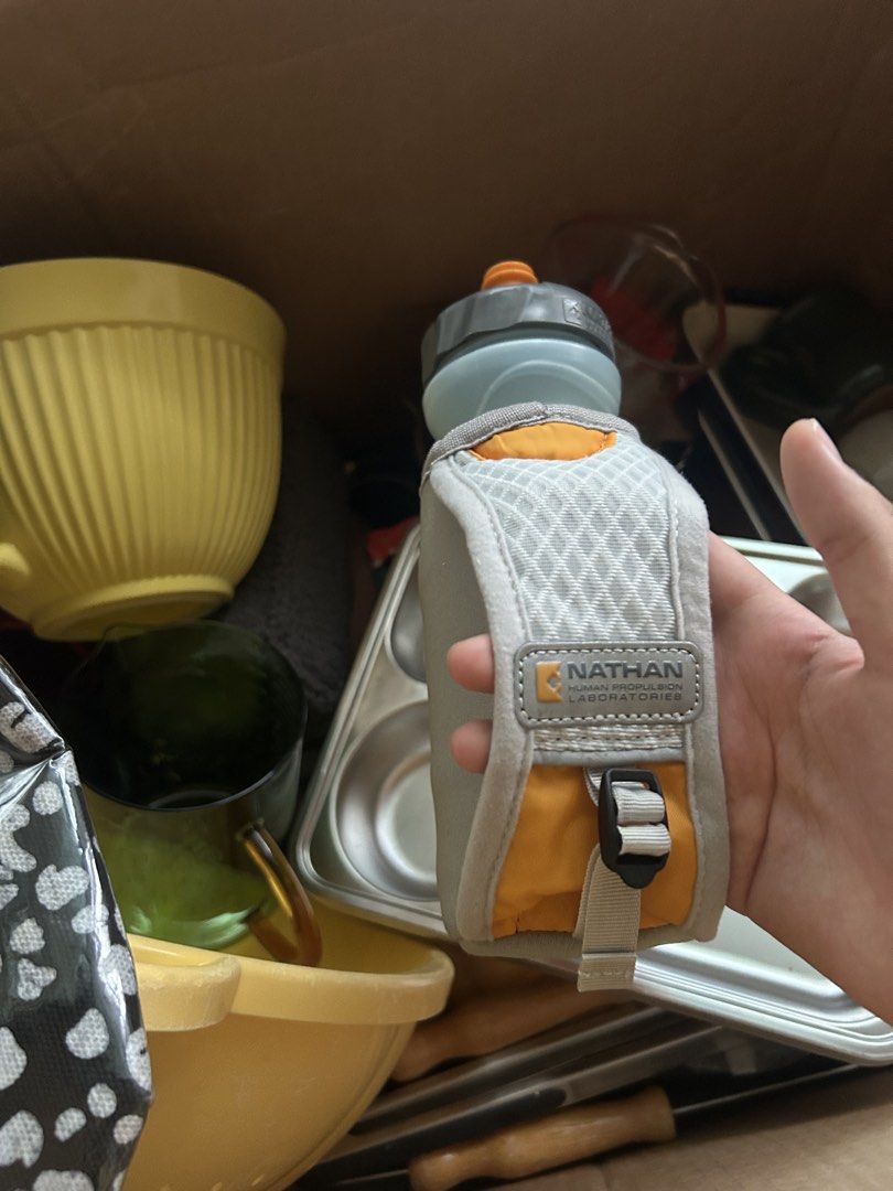 Nathan Orange Water Bottle Holder with Pouch (Category: Water Bottles & Tumblers) located in Manila. Submitted by keyscaninet (Listing ID 1450605856, Image 3). Description: - Nathan brand water bottle holder - Bright orange color with grey pouch - Mini backpack design with straps for easy carrying - Zippered pocket on the pouch for essentials - Ideal for running, hiking, and outdoor activities - Keeps your water bottle secure and your belongings 