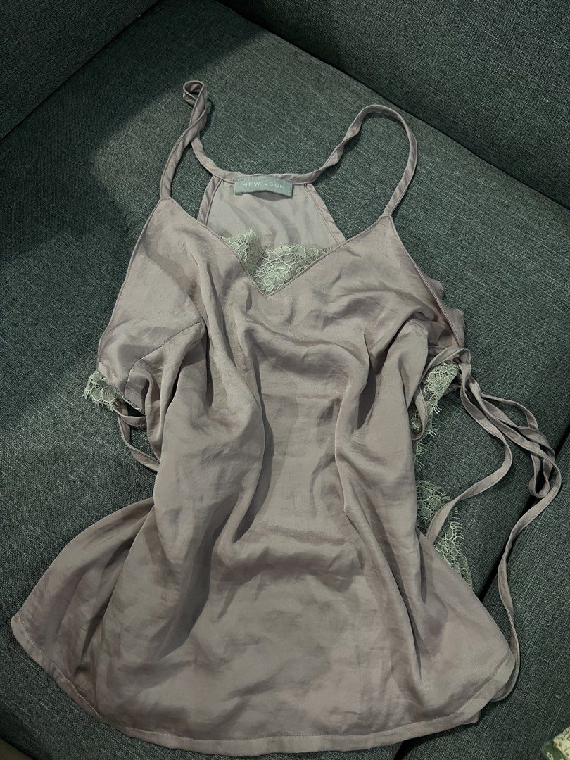 New Look Satin Lace Cami Top (Category: Sleeveless) located in Manila. Submitted by camieday04 (Listing ID 1450718426, Image 2). Description: - Light purple satin cami top - Delicate lace trim - Adjustable spaghetti straps - Cute side tie details - Estimated size: 10 - Versatile for layering or wearing on its own.