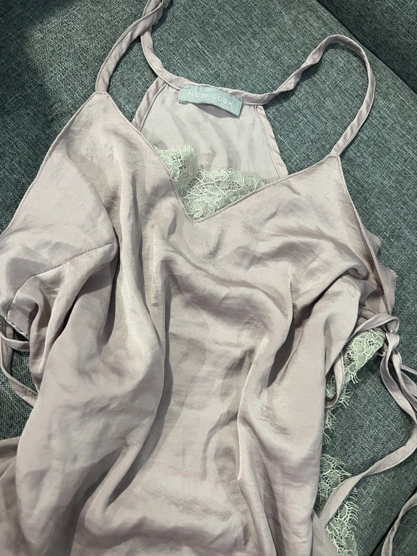 New Look Satin Lace Cami Top (Category: Sleeveless) located in Manila. Submitted by camieday04 (Listing ID 1450718426, Image 3). Description: - Light purple satin cami top - Delicate lace trim - Adjustable spaghetti straps - Cute side tie details - Estimated size: 10 - Versatile for layering or wearing on its own.