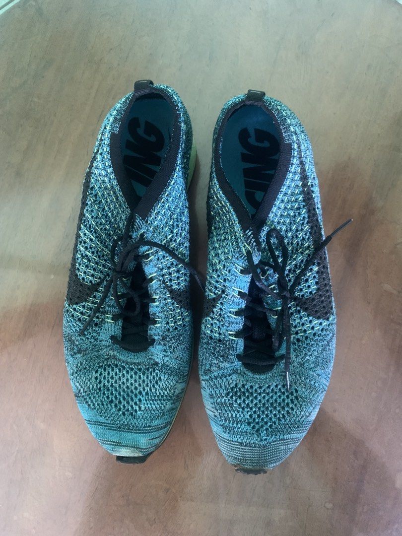 Nike Flyknit Racer Running Shoes (Category: Sneakers) located in Makati City. Submitted by ed_______ (Listing ID 1450687918, Image 2). Description: - Blue and black Nike Flyknit Racer shoes - Lightweight and breathable knit upper - Lace-up closure - Minor scuffing on toe area - Soles show wear but retain good grip - Ideal for running or casual wear - issue on the sold needs to be glued.