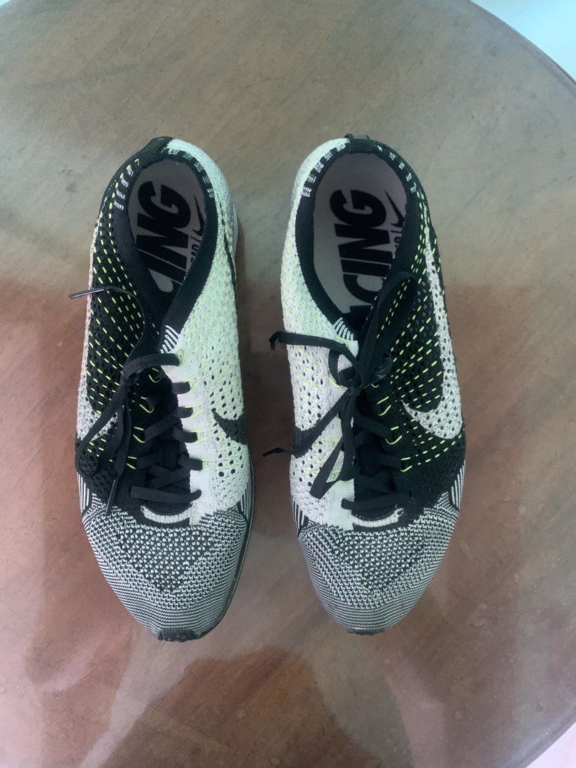 Nike Flyknit Racer Running Shoes (Category: Sneakers) located in Makati City. Submitted by ed_______ (Listing ID 1450688069, Image 2). Description: - Nike Flyknit Racer shoes - Color: Black, white, and neon yellow knit upper - Closure: Lace-up - Outsole: Rubber with good tread - Ideal for: Running or casual wear - Condition: Minor scuffs on soles from use - soles need to be glued.