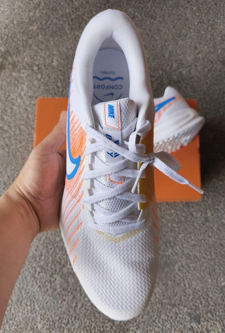 Nike Run Defy (Category: Sneakers) located in Calamba. Submitted by copanddrip (Listing ID 1450555661, Image 2). Description: - White Nike running shoes - Orange and blue accent colors - Breathable mesh upper - Durable rubber sole with excellent grip - Comes with original box - Ideal for running and casual wear.