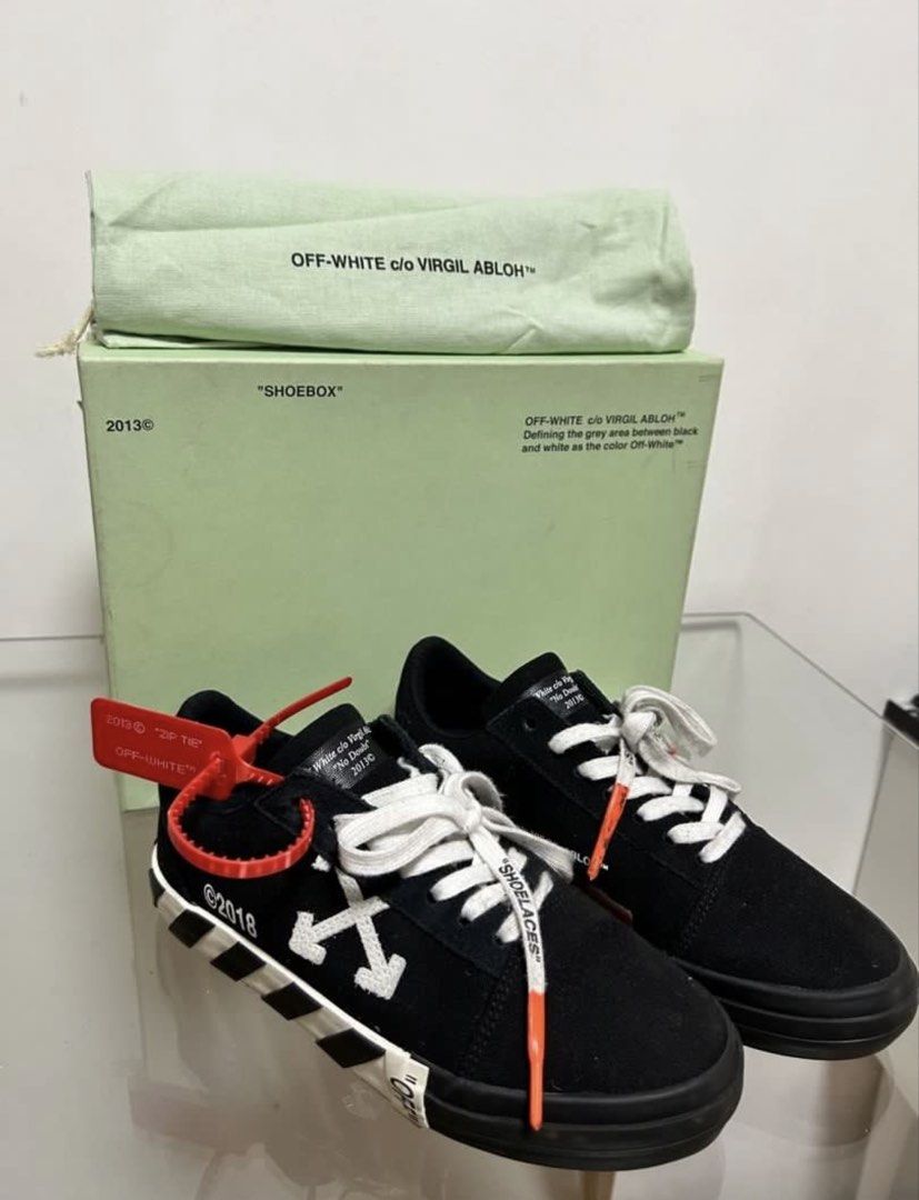 Off-White c/o Virgil Abloh Black Low Top Sneakers (Category: Sneakers) located in Del Monte. Submitted by cheezy_aissa (Listing ID 1450615929, Image 1). Description: - Brand: Off-White - Style: Low top sneakers - Color: Black - Features: Iconic diagonal stripes, arrow logo - Size: 36 - Includes: Original shoebox, dust bag.