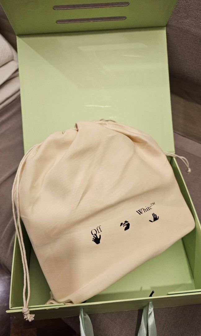 Off-White White Leather Top Handle Bag with Blue Arrows (Category: Luxury Bags & Wallets) located in Makati City. Submitted by mrsdm (Listing ID 1445252330, Image 3). Description: -Comes with strap and box - Iconic white arrow logo on the front - Unique white rope handle - Includes a detachable shoulder strap for versatile carrying - Perfect for adding a vibrant pop of color to any outfit.