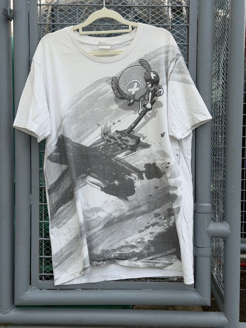 One Piece - Chopper COSPA (Category: Tshirts & Polo Shirts ) located in Manila. Submitted by random_thrifter99 (Listing ID 1450668422, Image 3). Description: - White t-shirt with a unique abstract graphic print. - Features a black and grey brushstroke effect. - Includes a character graphic on the upper right side. - Ideal for everyday casual wear. -22x29" -needs wash.