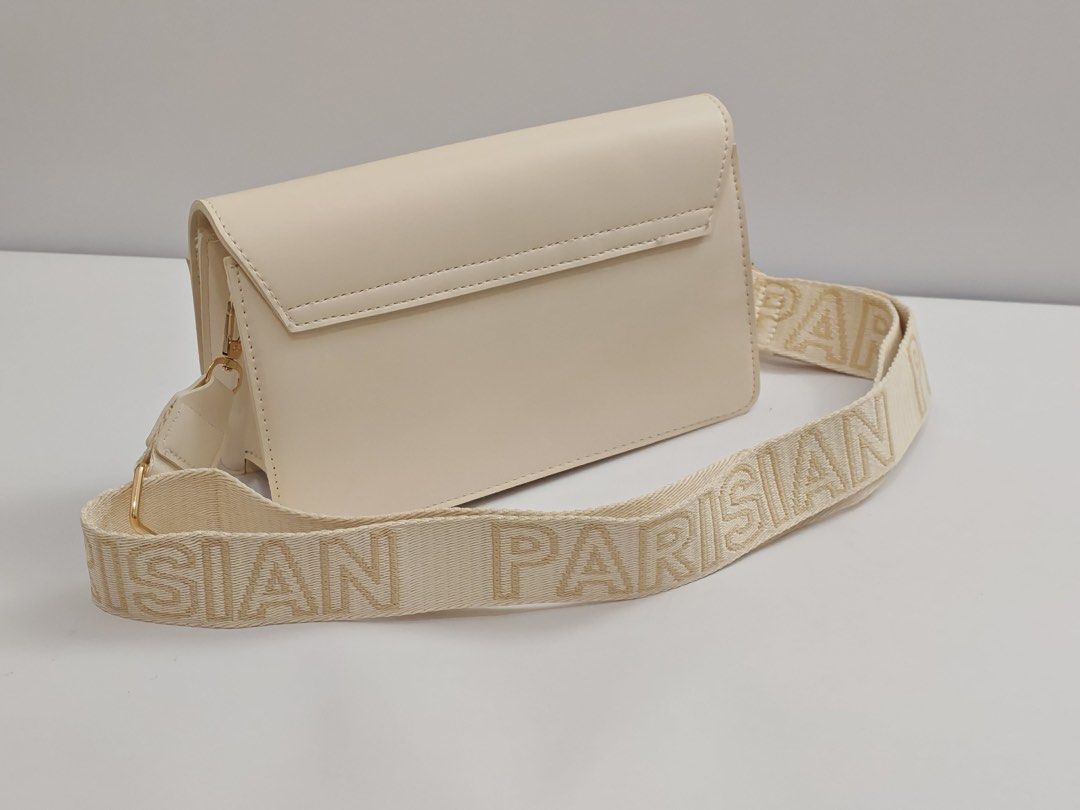 Parisian White crossbody bag with gold hardware and patterned strap (Category: Cross-body Bags) located in Quezon City. Submitted by krismocha (Listing ID 1450694801, Image 2). Description: - White colored crossbody bag - Features a chic gold clasp closure - Stylish woven strap design - Ideal for everyday use - Perfectly fits your daily essentials - Clean and simple aesthetic - Pick up at Quezon City Area: Dream Tower near Eastwood.