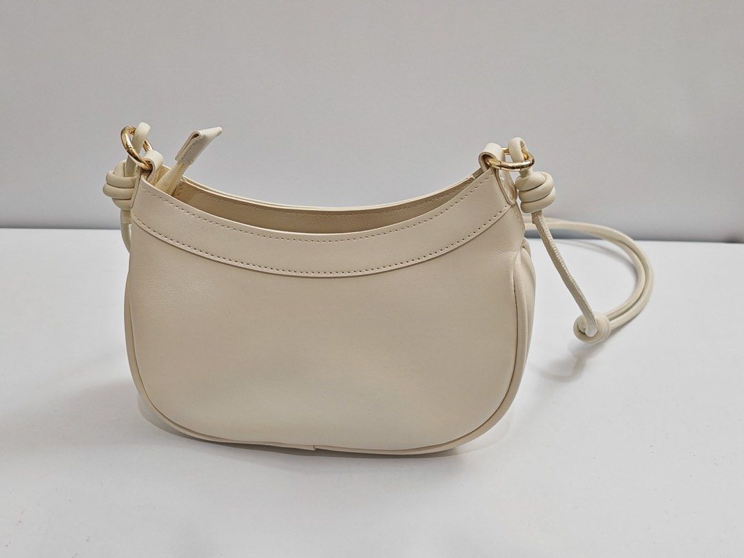 Parisian White Shoulder Bag with Gold Hardware (Category: Shoulder Bags) located in Quezon City. Submitted by krismocha (Listing ID 1450694585, Image 1). Description: - Cute white shoulder bag - Features a knot detail on the adjustable strap - Accented with gold hardware - Simple and chic design - Ideal for everyday wear - Pick up at Quezon City Area: Dream Tower near Eastwood.