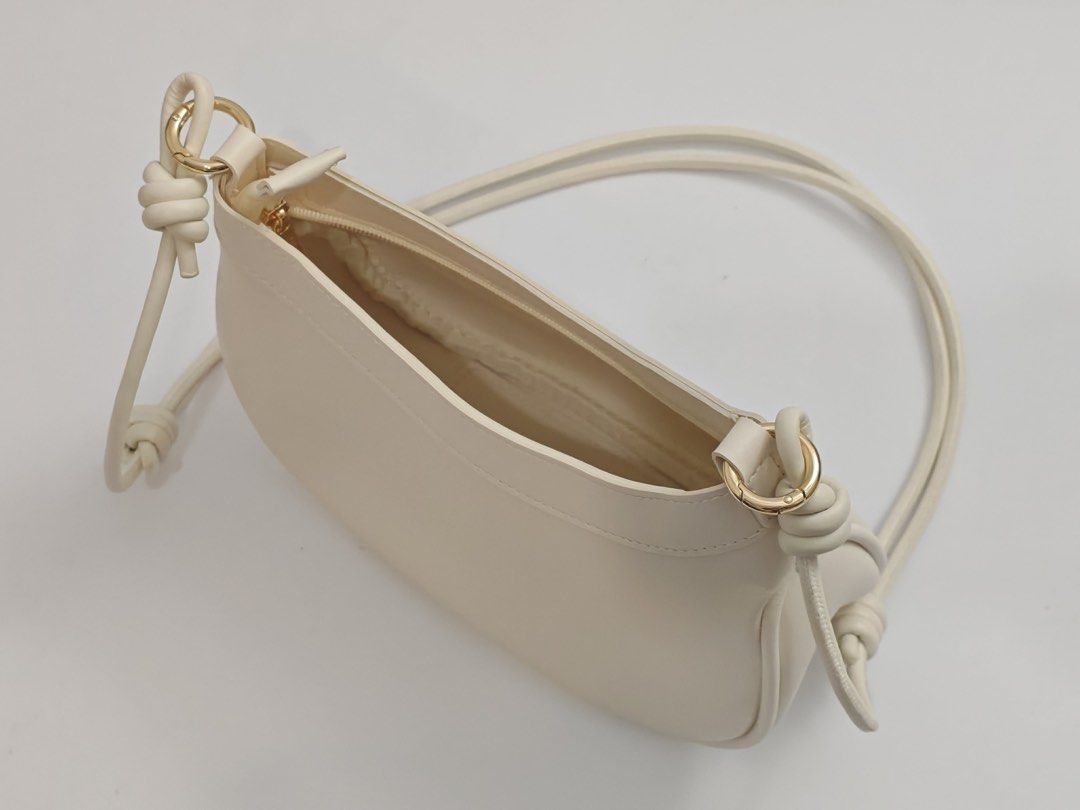 Parisian White Shoulder Bag with Gold Hardware (Category: Shoulder Bags) located in Quezon City. Submitted by krismocha (Listing ID 1450694585, Image 3). Description: - Cute white shoulder bag - Features a knot detail on the adjustable strap - Accented with gold hardware - Simple and chic design - Ideal for everyday wear - Pick up at Quezon City Area: Dream Tower near Eastwood.