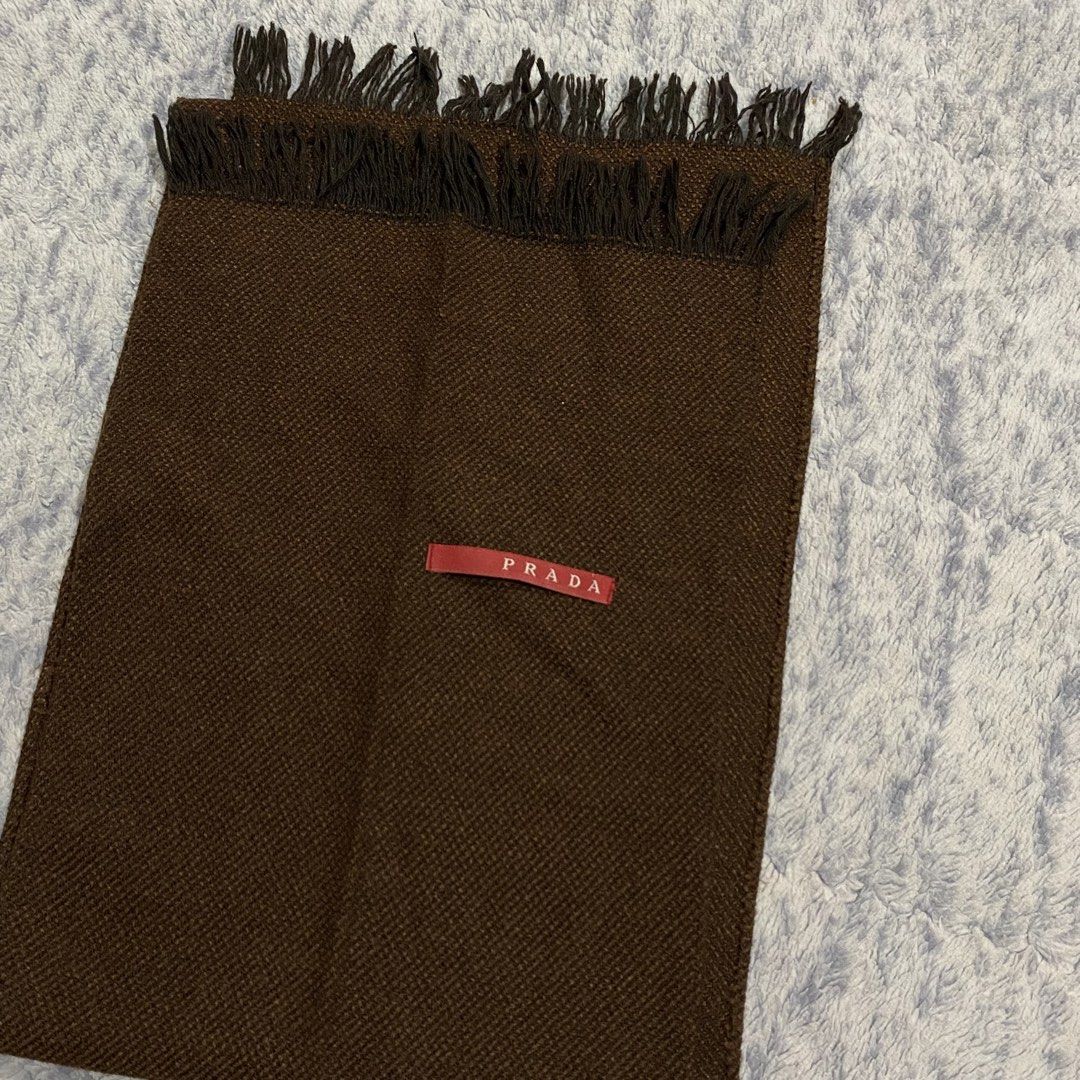Prada Brown Wool Scarf Made in Italy (Category: Scarves) located in Dipolog. Submitted by thriftcher (Listing ID 1450663657, Image 2). Description: - Authentic Prada scarf - Classic brown color with fringe detail - Made in Italy - Features Prada logo tag - Ideal for staying warm in style - Please check photos for condition details Good as new Dm..