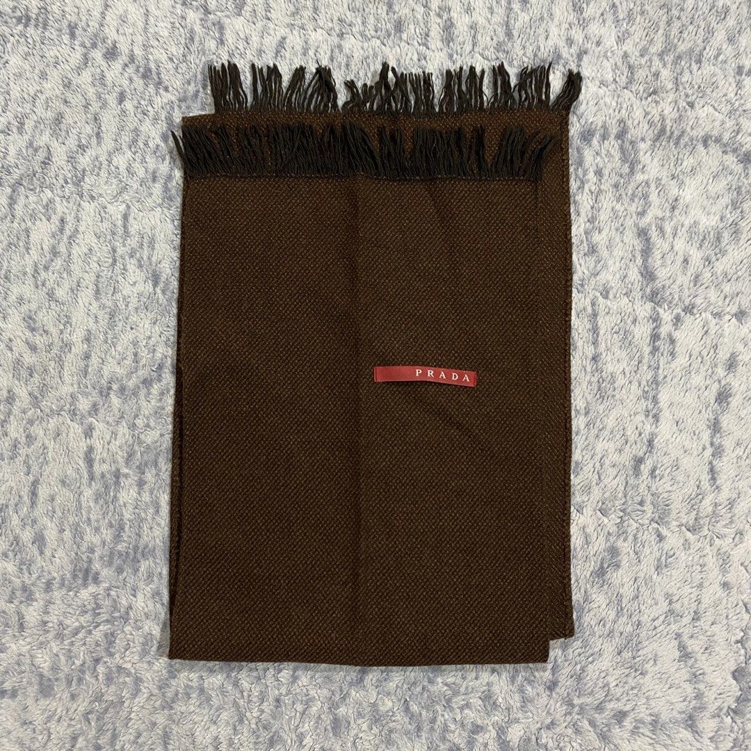 Prada Brown Wool Scarf Made in Italy (Category: Scarves) located in Dipolog. Submitted by thriftcher (Listing ID 1450663657, Image 1). Description: - Authentic Prada scarf - Classic brown color with fringe detail - Made in Italy - Features Prada logo tag - Ideal for staying warm in style - Please check photos for condition details Good as new Dm..