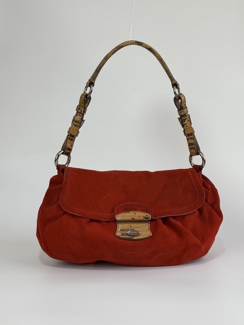 Prada Orange Suede Push-lock Baguette (Category: Luxury Bags & Wallets) located in Burgos, Ilocos Sur. Submitted by robynperalta05 (Listing ID 1450645690, Image 1). Description: Orange suede exterior Lilac leather lining Silver-tone hardware Push-lock closure Animal skin embossed shoulder strap Signs of wear Dirt and faded on some parts of the suede, consistent with its vintage nature. Leather separation on some parts of the flap Press marks This