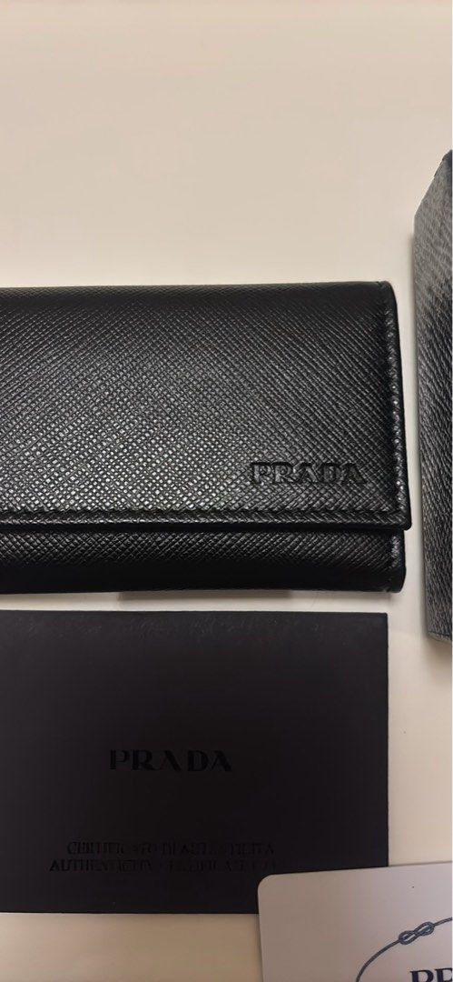 Prada Saffiano Leather 6 Key Holder Nero (Category: Luxury Bags & Wallets) located in Makati City. Submitted by ed_______ (Listing ID 1450684817, Image 2). Description: - Authentic Prada Key Holder - Material: Black Saffiano Leather - Includes: Original Box, Authenticity Card, Dust Pouch - Features: 6 Key Hooks - Origin: Made in Italy - Perfect for organizing your keys in style..
