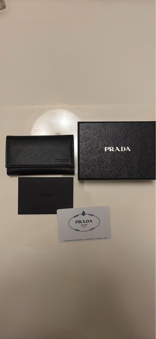 Prada Saffiano Leather 6 Key Holder Nero (Category: Luxury Bags & Wallets) located in Makati City. Submitted by ed_______ (Listing ID 1450684817, Image 1). Description: - Authentic Prada Key Holder - Material: Black Saffiano Leather - Includes: Original Box, Authenticity Card, Dust Pouch - Features: 6 Key Hooks - Origin: Made in Italy - Perfect for organizing your keys in style..