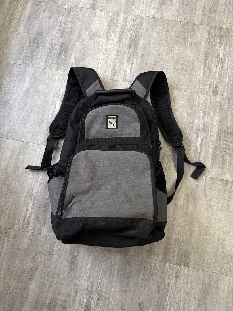 Puma Backpack Black Grey (Category: Backpacks) located in Manila. Submitted by lostnfound_ph (Listing ID 1450621937, Image 1). Description: - Puma backpack in black and grey. - Features multiple compartments and pockets for organization. - Adjustable shoulder straps ensure a comfortable fit. - Ideal for school or everyday carry. - Shows some signs of wear on the bottom..