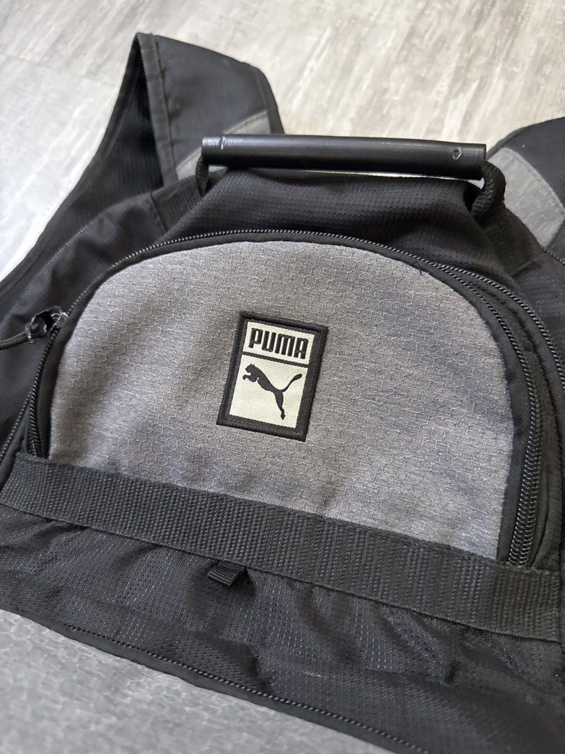 Puma Backpack Black Grey (Category: Backpacks) located in Manila. Submitted by lostnfound_ph (Listing ID 1450621937, Image 2). Description: - Puma backpack in black and grey. - Features multiple compartments and pockets for organization. - Adjustable shoulder straps ensure a comfortable fit. - Ideal for school or everyday carry. - Shows some signs of wear on the bottom..
