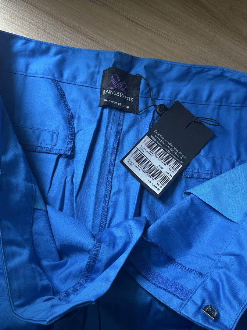 PLAINS & PRINTS Blue Trousers Size L (Category: Other Bottoms) located in Quezon City. Submitted by prelovednd21 (Listing ID 1450602154, Image 2). Description: - Brand: RAINS & PRINTS - Color: Blue - Size: L (fits UK 12) - Fit: Relaxed - Features: Blue ribbon detail on pockets - Occasion: Casual wear or dressing up.