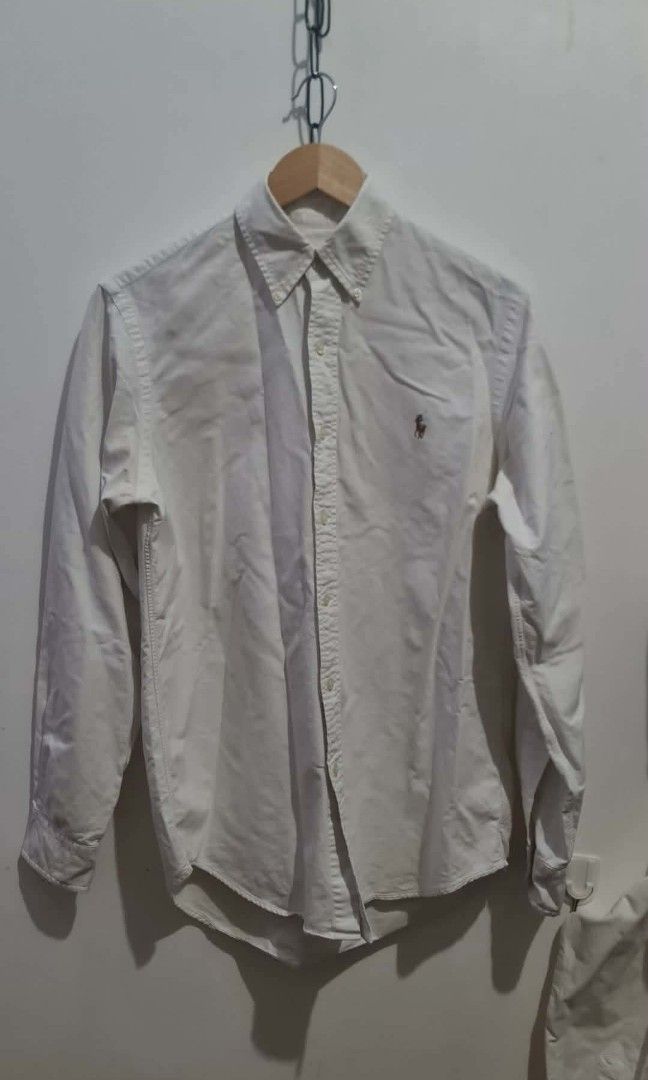 Ralph Lauren White Oxford Button-Down Shirt (Category: Tshirts & Polo Shirts ) located in Tabaco. Submitted by emmanyul (Listing ID 1450529845, Image 3). Description: - Classic white Oxford shirt by Ralph Lauren - Brand new condition - 21x29 - for medium sizing - No issues - Authentic - Needs Wash - Negotiable for surebuyer - Features iconic embroidered polo player logo on chest - Button-down collar and long sleeves - Versatile for casual or smar
