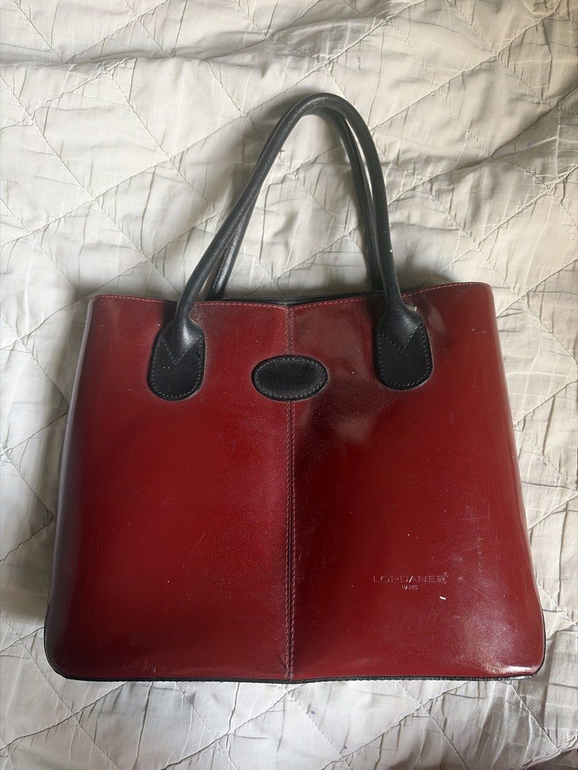 Red Leather Tote Bag (Category: Luxury Bags & Wallets) located in Caloocan City. Submitted by fuyaei (Listing ID 1450625368, Image 1). Description: - Classic red leather tote bag - Black handles and trim - Zipper closure - Minor scuffs on leather (expected with use) - Plenty of life left, great for everyday use - never used - lalamove or jnt (qc novaliches located) .