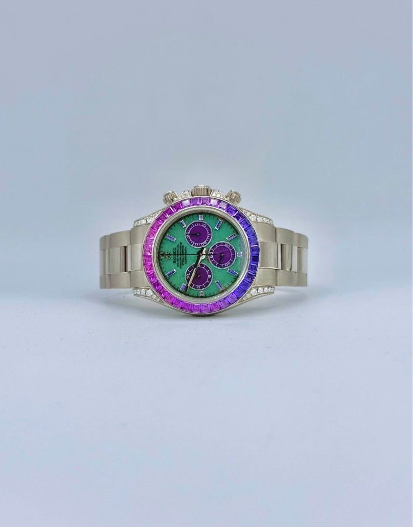 Rolex Daytona Rainbow Gemstone Watch (Category: Luxury Watches) located in Manila. Submitted by supermom888 (Listing ID 1450573175, Image 2). Description: - Rolex Daytona timepiece - Eye-catching green dial - Distinctive purple sub-dials - Bezel adorned with vibrant rainbow gemstones - Includes original Rolex box - A statement of luxury and style.