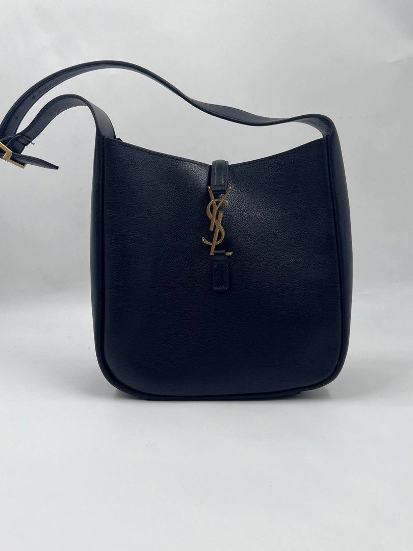 Saint Laurent Black Leather Hobo Bag (Category: Luxury Bags & Wallets) located in Malabon City. Submitted by truepenguin_22c2e4 (Listing ID 1450733877, Image 1). Description: - Saint Laurent hobo bag - Luxurious black leather - Iconic gold YSL logo hardware - Adjustable shoulder strap with buckle - Spacious interior for daily essentials - Timeless and versatile design .