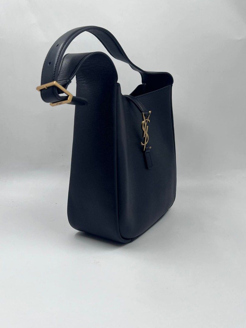 Saint Laurent Black Leather Hobo Bag (Category: Luxury Bags & Wallets) located in Malabon City. Submitted by truepenguin_22c2e4 (Listing ID 1450733877, Image 2). Description: - Saint Laurent hobo bag - Luxurious black leather - Iconic gold YSL logo hardware - Adjustable shoulder strap with buckle - Spacious interior for daily essentials - Timeless and versatile design .